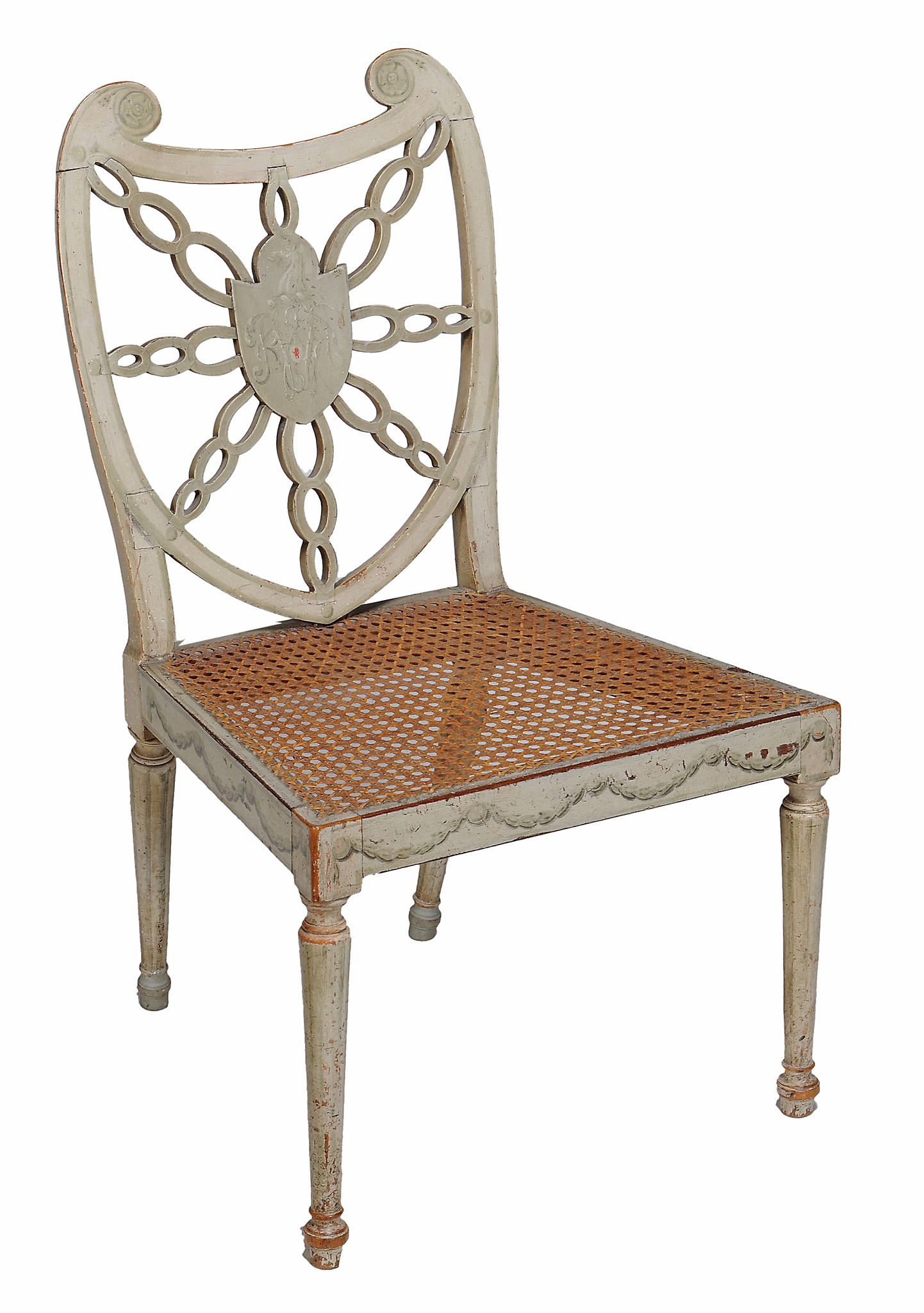 A George III painted chair, circa 1775  ,  the pierced shield shaped back with a central crest and