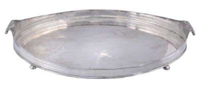 A silver on copper oval galleried tray with twin shell handles,   early 20th century, 66cm (26in)