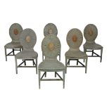 A set of six George III painted hall chairs, circa 1780, the oval backs with a radiating design