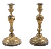 A pair of French ormolu candlesticks,   last quarter 18th century,  with foliate cast urn capitals