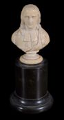 A carved ivory bust of a cleric,   French, 18th century,  wearing long hair to his shoulders, on a