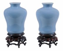 A pair of claire de lune glazed vases, Qing Dynasty, 19th century,  on wood stands,   22.5cm high