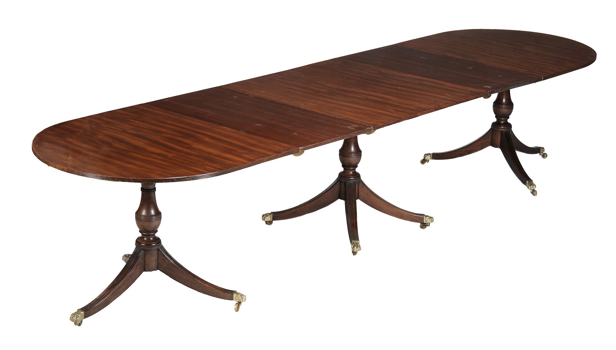 A mahogany triple pedestal extending dining table, in George III style,   20th century, the