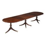 A mahogany triple pedestal extending dining table, in George III style,   20th century, the