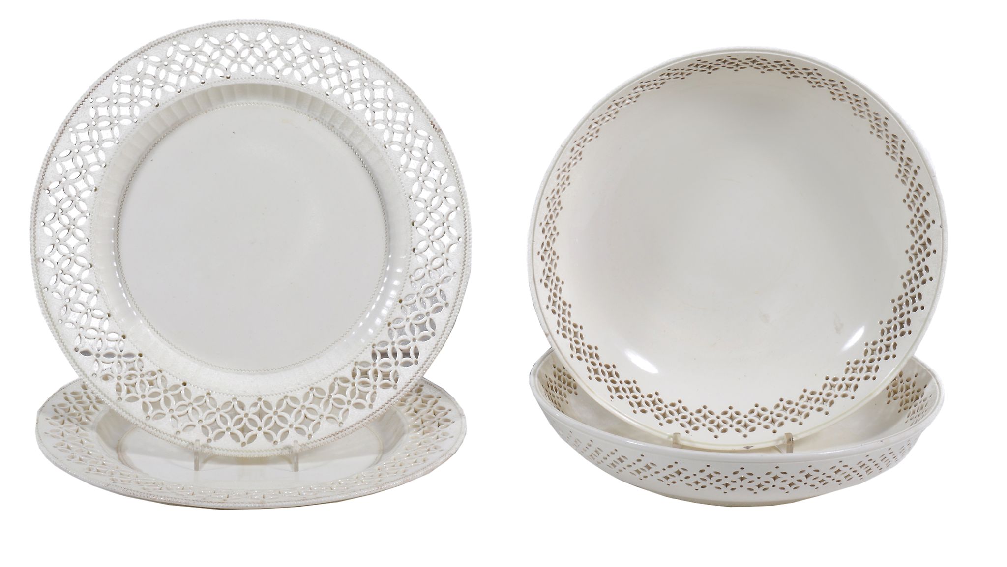A pair of English creamware shallow bowls and associated plates,   circa 1775-85,  with pierced