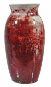 A Ruskin Pottery high fired ovoid vase,   in a flambe red over a white ground, impressed marks,