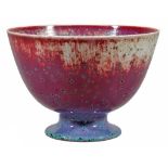 A Ruskin Pottery high fired footed bowl,   in a flambe red glaze with lavender tone and green glaze