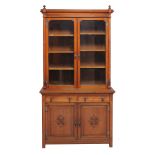 An Arts and Crafts walnut bookcase  , late 19th/ early 20th century, the moulded cornice above two