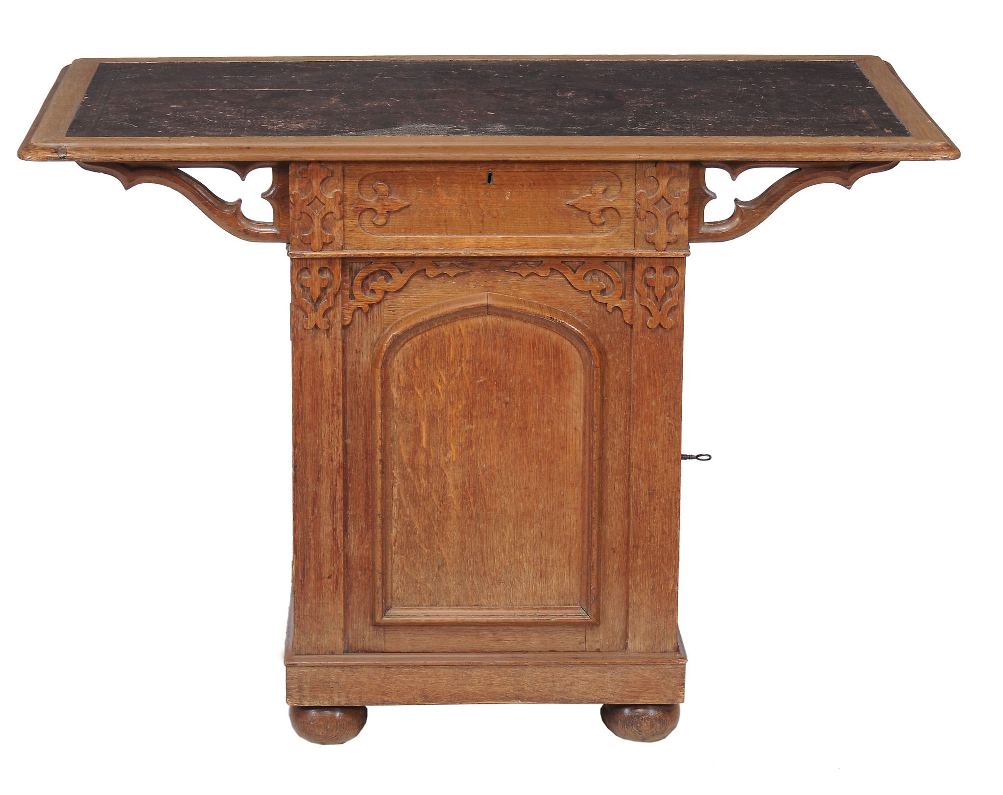 A Gothic Revival oak pedestal writing table  , circa 1880, the tooled leather inset top above a