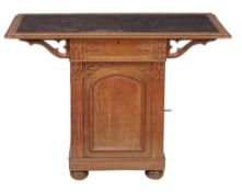 A Gothic Revival oak pedestal writing table  , circa 1880, the tooled leather inset top above a