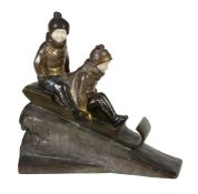 H. M. White, an Art Deco patinated and gilt bronze and ivory model of two children on a sledge,