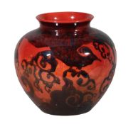 Charles Noke for Royal Doulton, a Sung flambe baluster vase,   richly painted with a large peacock