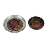 Pomegranate, two Moorcroft dishes,   1920s, the first on a green ground with a mounted plated
