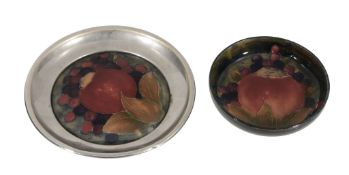 Pomegranate, two Moorcroft dishes,   1920s, the first on a green ground with a mounted plated