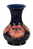 Big Poppy, a Moorcroft baluster vase,   1920s, on a deep blue ground, green painted signature and