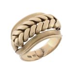 An gold coloured dress ring, with a pierced broad front panel, stamped 18, 17  An gold coloured