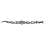 A green tourmaline bracelet, composed of openwork ribbon bow links set with...  A green tourmaline