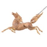 An 18 carat gold horse brooch , the textured prancing horse  An 18 carat gold horse brooch  , the