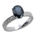 A sapphire and diamond ring, the central oval shaped sapphire in a claw...  A sapphire and diamond