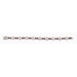 A ruby and diamond bracelet, the articulated bracelet composed of foliate...  A ruby and diamond