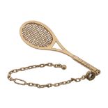 A tennis racket fob by Dunhill, the gold coloured racket measuring 6  A tennis racket fob by