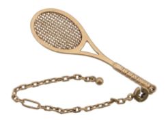 A tennis racket fob by Dunhill, the gold coloured racket measuring 6  A tennis racket fob by