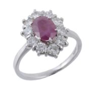 A ruby and diamond cluster ring, the central oval shaped ruby claw set...  A ruby and diamond