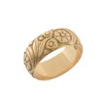 An 18 carat gold floral band ring , with floral chased decoration  An 18 carat gold floral band ring