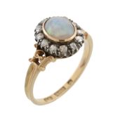 An opal and diamond cluster ring, the central oval shaped opal collet set...  An opal and diamond