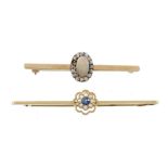 An opal and diamond brooch, the central oval shaped opal within a surround...  An opal and diamond