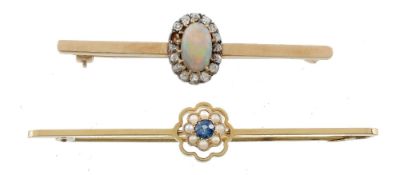 An opal and diamond brooch, the central oval shaped opal within a surround...  An opal and diamond