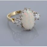 An 18 carat gold opal and diamond ring, the central oval shaped opal claw...  An 18 carat gold