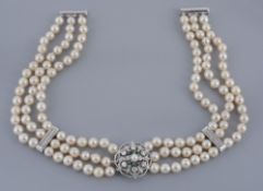 A three strand cultured pearl necklace, the choker composed of uniform...  A three strand cultured