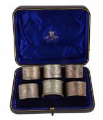 A late Victorian cased set of five silver napkin rings by Josiah Williams & Co  A late Victorian