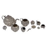 An Indian silver coloured three piece lobed circular tea service , unmarked  An Indian silver