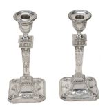 A pair of silver canted-square candlesticks by James Deakin & Sons  A pair of silver canted-square