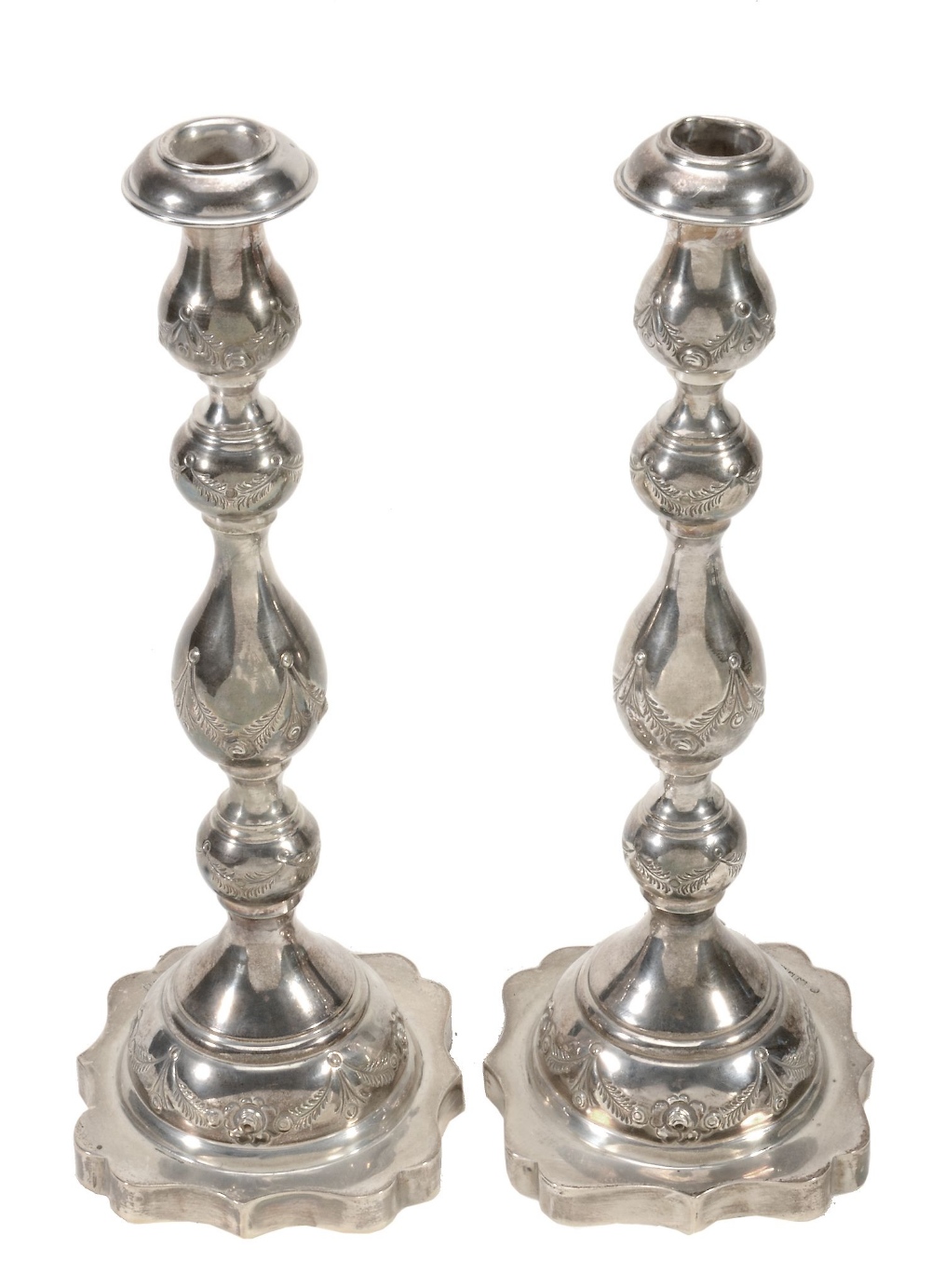 A pair of silver candlesticks by Rosenzweig, Taitelbaum & Co  A pair of silver candlesticks by