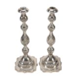 A pair of silver candlesticks by Rosenzweig, Taitelbaum & Co  A pair of silver candlesticks by