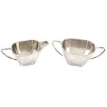 A silver facetted oblong sugar basin and a cream jug by George Wish  A silver facetted oblong