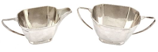 A silver facetted oblong sugar basin and a cream jug by George Wish  A silver facetted oblong