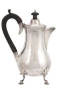 A silver baluster hot water jug by Goldsmiths & Silversmiths Co. Ltd  A silver baluster hot water