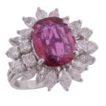 A ruby and diamond cluster ring, the oval cut ruby estimated to weigh 1  A ruby and diamond