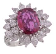 A ruby and diamond cluster ring, the oval cut ruby estimated to weigh 1  A ruby and diamond