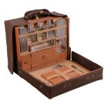 A pigskin rectangular travelling case with silver fittings by Asprey & Co  A pigskin rectangular