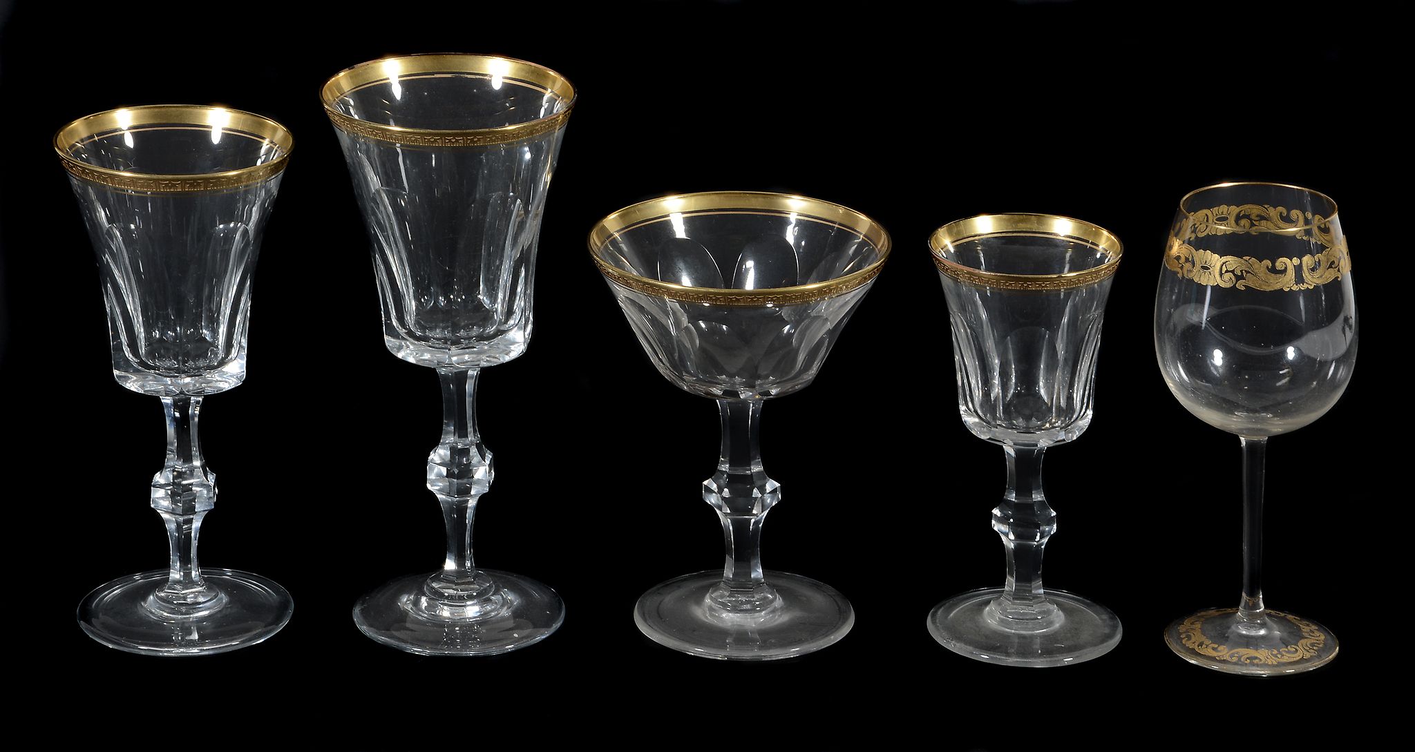 A clear glass and gilt part table service in the Baccarat style  A clear glass and gilt part table