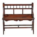 A Victorian mahogany hall bench, circa 1890, in the Shoolbred manner  A Victorian mahogany hall