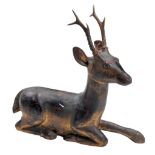 A carved, painted and giltwood model of a recumbent stag, 19th century  A carved, painted and