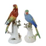 Two similar German porcelain models of parrots, 20th century, 26cm and 29cm high  Two similar German