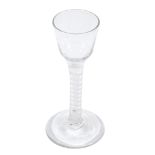 An opaque-twist wine glass, circa 1765, the ogee bowl supported on a...  An opaque-twist wine glass,