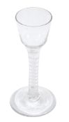 An opaque-twist wine glass, circa 1765, the ogee bowl supported on a...  An opaque-twist wine glass,